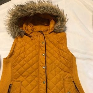 Woman’s Sz M Quilted Faux Fur Hooded full zip Vest. Color is a Mustard/Orange.